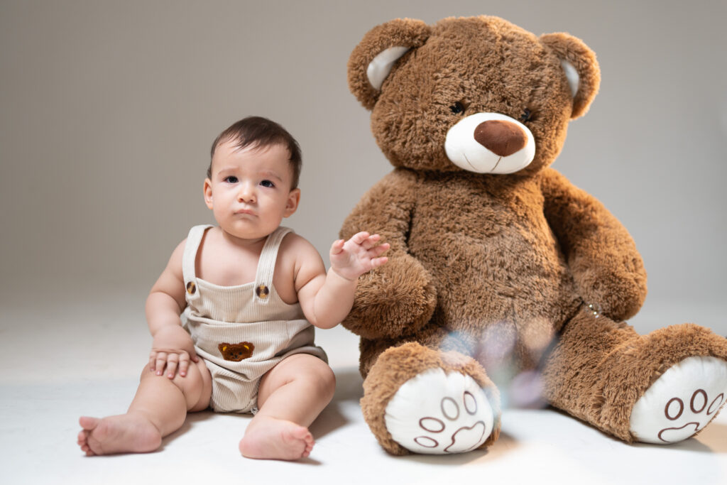 Sesión de fotos de bebé con oso de peluche en estudio en Cali